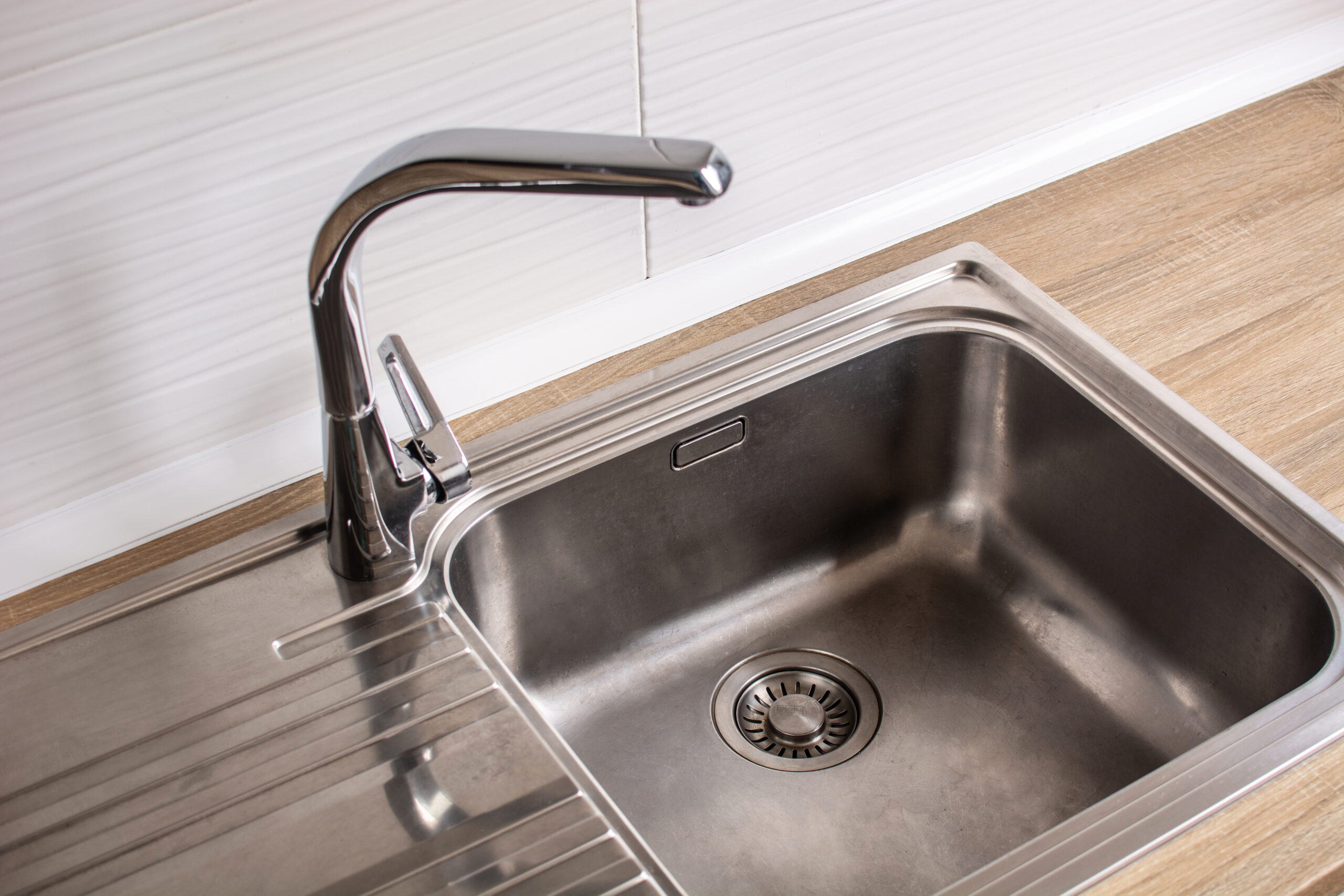 A bathroom sink with dirty, backed-up water due to a clogged drain
